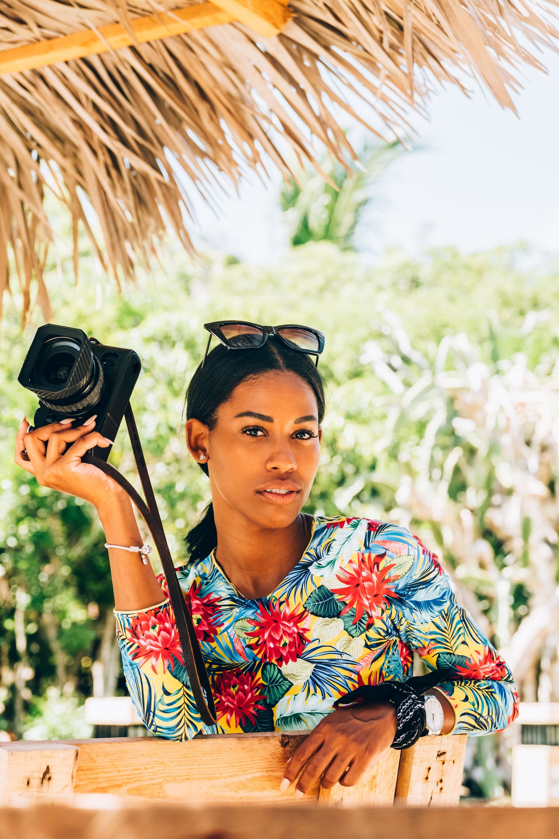 Young Black woman with retro digital camera