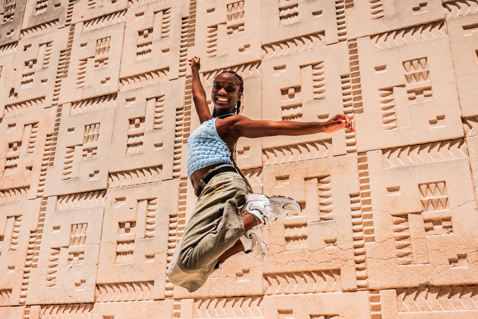Portrait of young woman jumping outdoors
