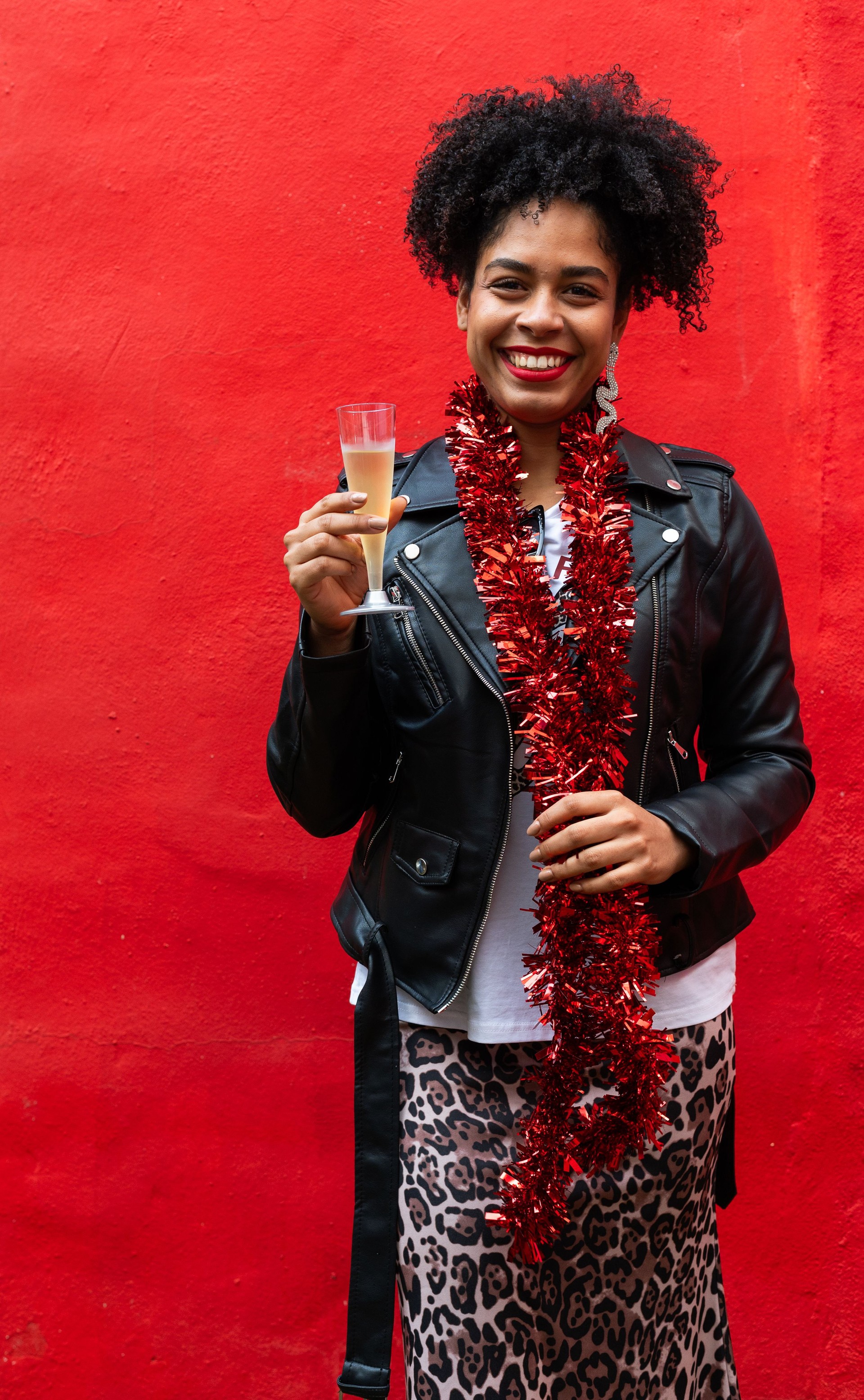 Young woman holding champagne flute celebrating christmas party